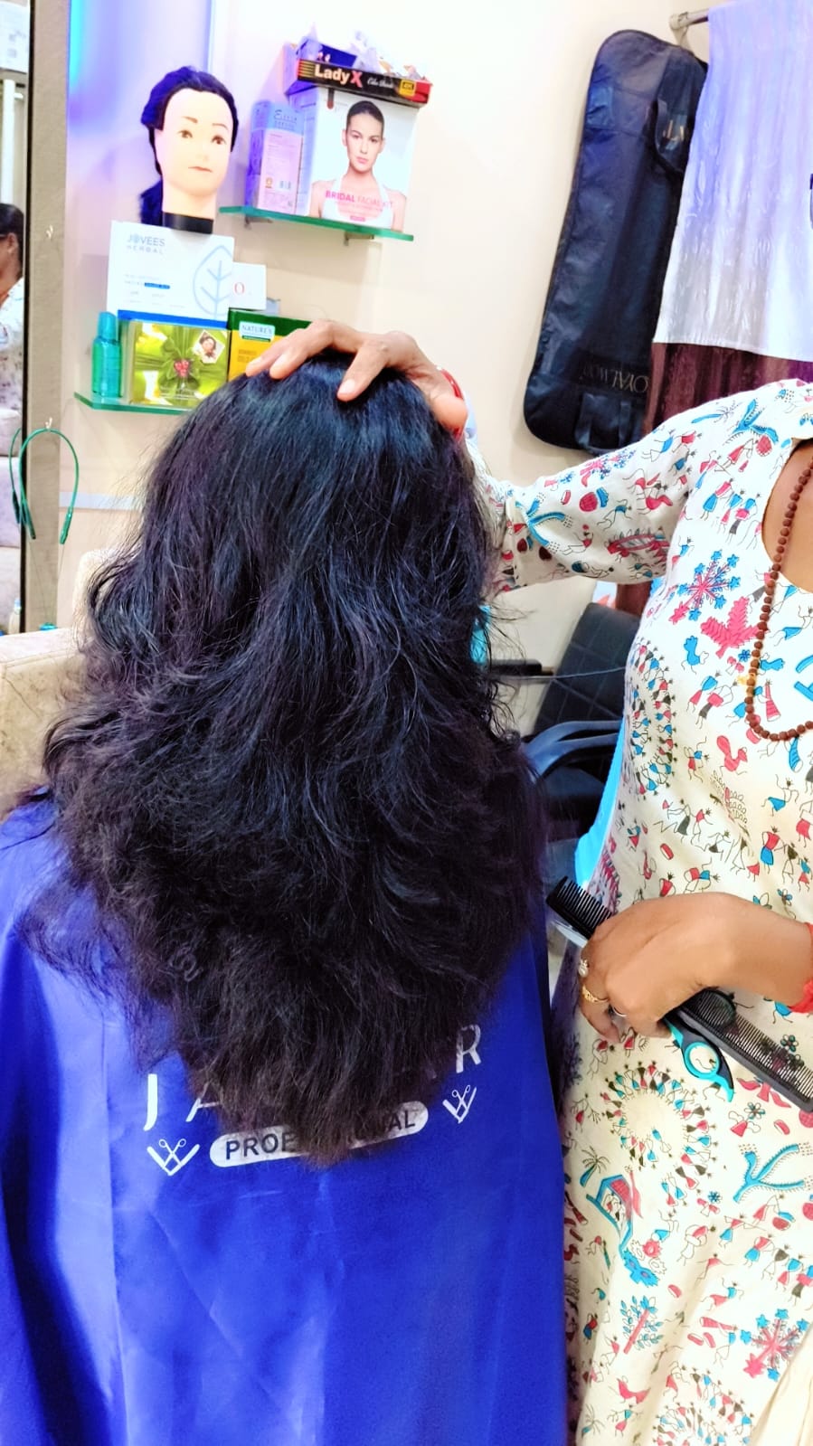 Stylist presenting a finished sleek hair look